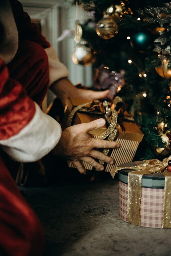 Santa Claus placing gifts under a beautifully decorated Christmas tree, capturing the holiday spirit.