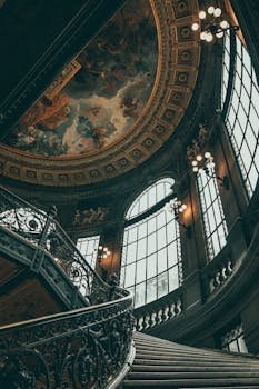 Beautiful low-angle view of the ornate interior and ceiling art of the Mexican National Art Museum in Mexico City.