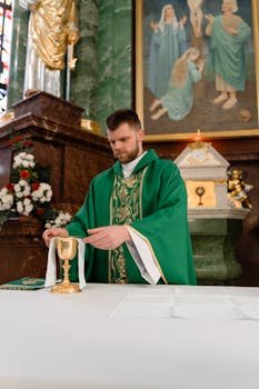 A priest in green vestments preparing a golden chalice during communion in a church.